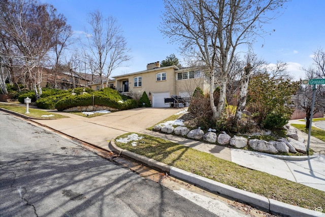 1376 Granada Dr, Bountiful, UT 84010 - view of front of property with driveway, a chimney, a garage, and stucco siding