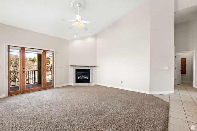 208 N Guidelight Dr, Cedar City, UT 84720 - unfurnished living room featuring light tile patterned flooring, high vaulted ceiling, a ceiling fan, baseboards, and light colored carpet