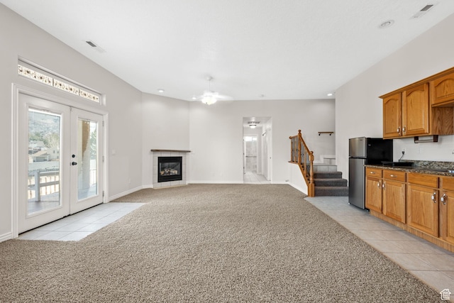 208 N Guidelight Dr, Cedar City, UT 84720 - living room featuring stairs, french doors, visible vents, light carpet, and ceiling fan
