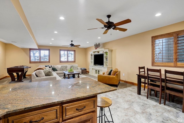 1603 E Millbrook Way, Bountiful, UT 84010 - kitchen with recessed lighting, brown cabinetry, a ceiling fan, light stone countertops, and a kitchen breakfast bar