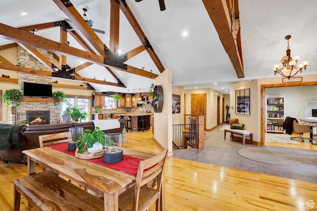 1603 E Millbrook Way, Bountiful, UT 84010 - dining area with light wood-type flooring, a fireplace, beam ceiling, a chandelier, and high vaulted ceiling