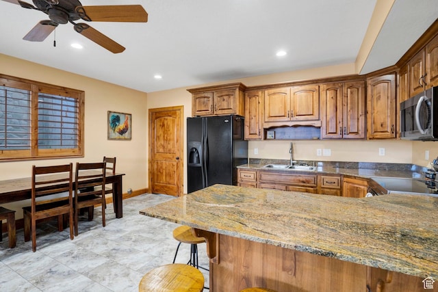 1603 E Millbrook Way, Bountiful, UT 84010 - kitchen featuring black fridge with ice dispenser, stainless steel microwave, stove, ceiling fan, and a kitchen breakfast bar