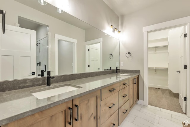 3240 W Oxford Loop Unit 219, Mountain Green, UT 84050 - full bathroom with marble finish floor, double vanity, a sink, and a stall shower