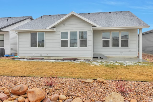 3240 W Oxford Loop Unit 219, Mountain Green, UT 84050 - rear view of property with a yard and roof with shingles