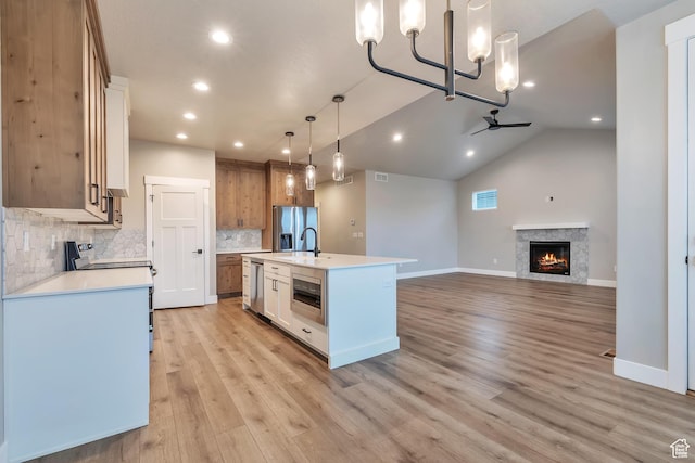 3240 W Oxford Loop Unit 219, Mountain Green, UT 84050 - kitchen featuring a notable chandelier, light countertops, light wood-style floors, and appliances with stainless steel finishes