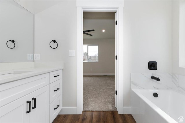174 N 300 W, Preston, ID 83263 - full bathroom with vanity, baseboards, a tub to relax in, and wood finished floors