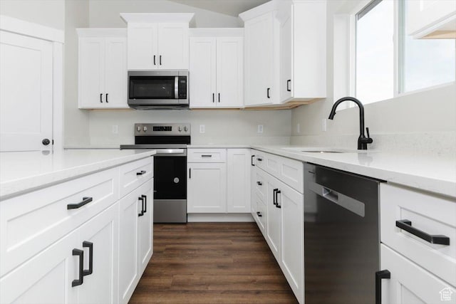 174 N 300 W, Preston, ID 83263 - kitchen featuring white cabinetry, dark wood-style floors, a sink, and appliances with stainless steel finishes