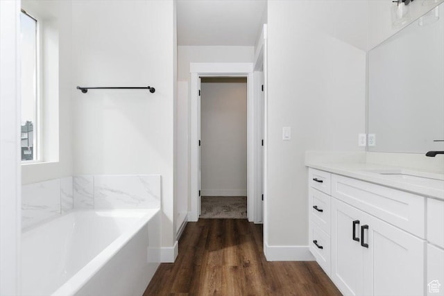 174 N 300 W, Preston, ID 83263 - bathroom with baseboards, wood finished floors, vanity, and a bath