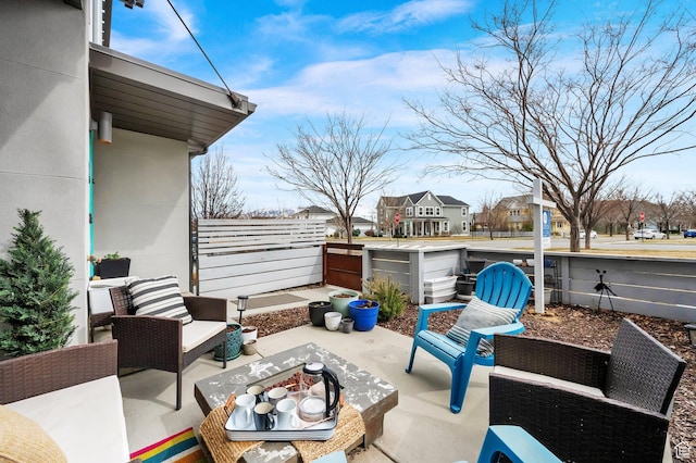 view of patio with an outdoor living space and fence
