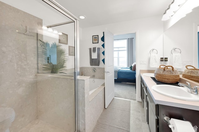 full bathroom featuring a garden tub, tile patterned flooring, a sink, a stall shower, and double vanity