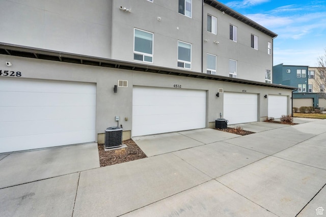 exterior space with central air condition unit and stucco siding