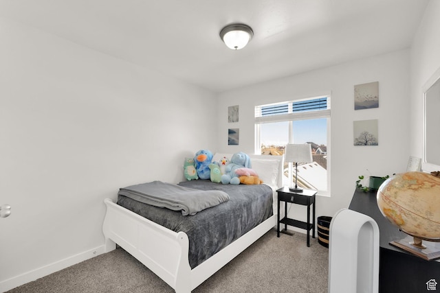 bedroom featuring baseboards and carpet