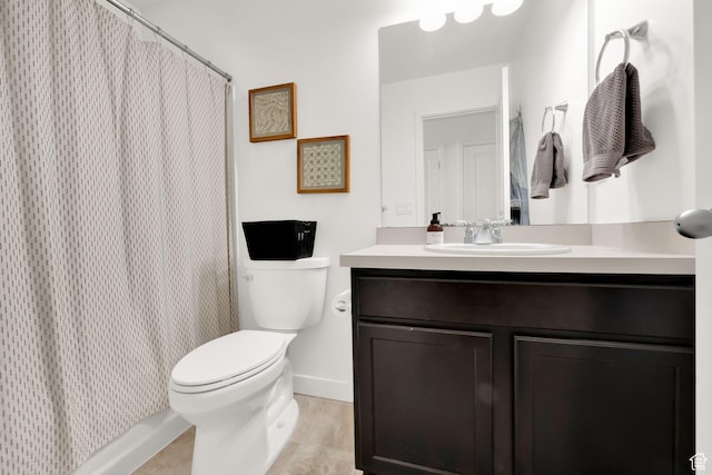 bathroom with baseboards, curtained shower, toilet, vanity, and tile patterned floors
