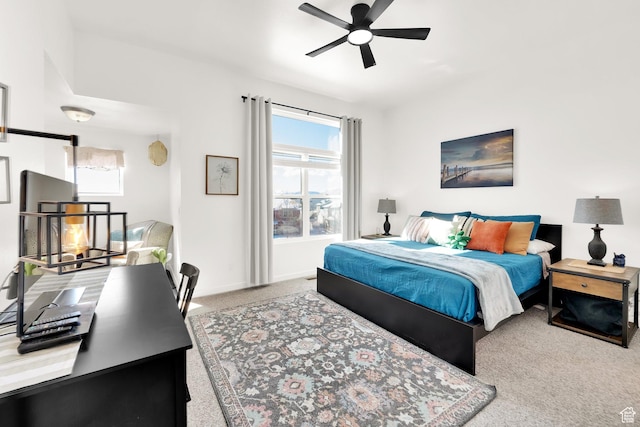 carpeted bedroom featuring multiple windows, baseboards, and ceiling fan