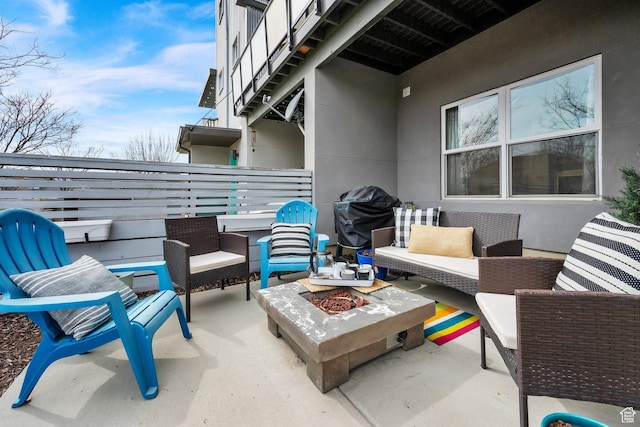 view of patio / terrace with an outdoor living space with a fire pit