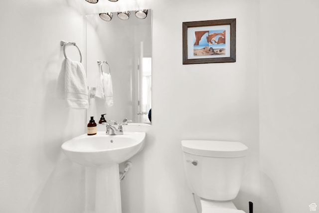 half bath with a sink and toilet