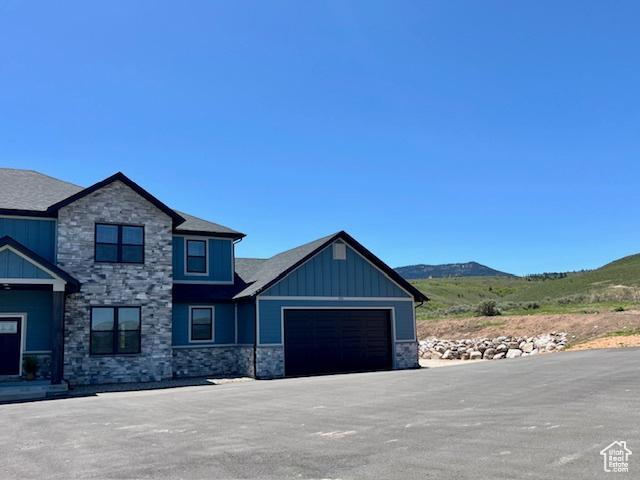 650 Blue Sage Dr, Fish Haven, ID 83287 - craftsman inspired home with stone siding, an attached garage, a mountain view, and board and batten siding