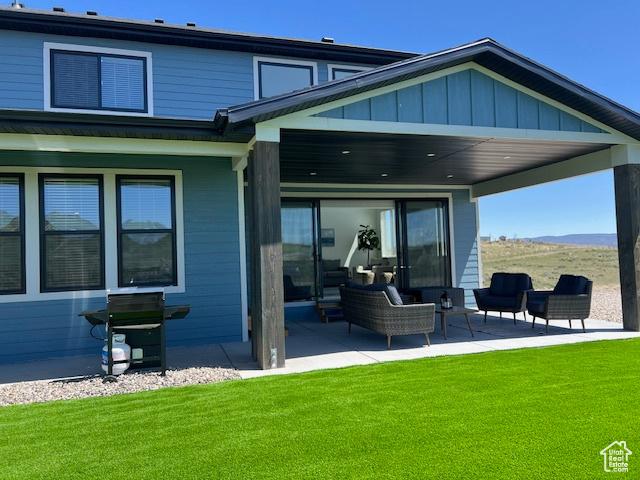 650 Blue Sage Dr, Fish Haven, ID 83287 - back of property featuring a lawn, a patio, and board and batten siding