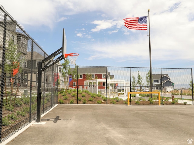 view of basketball court featuring fence and community basketball court