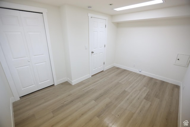 unfurnished bedroom featuring baseboards and light wood-style flooring