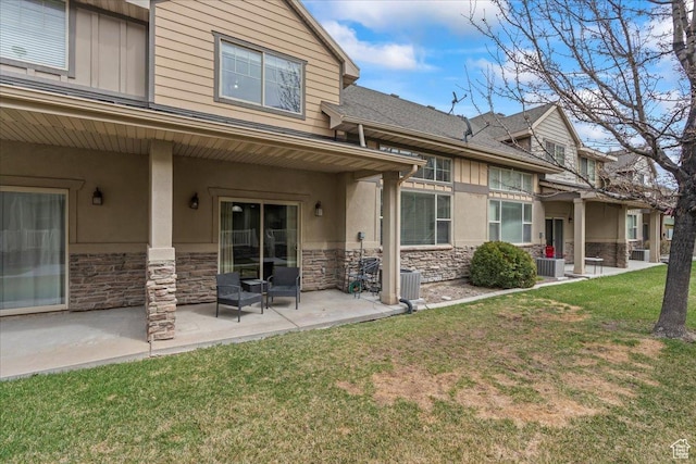 576 E 1540 S, Lehi, UT 84043 - back of house featuring stone siding, central air condition unit, stucco siding, a lawn, and a patio area