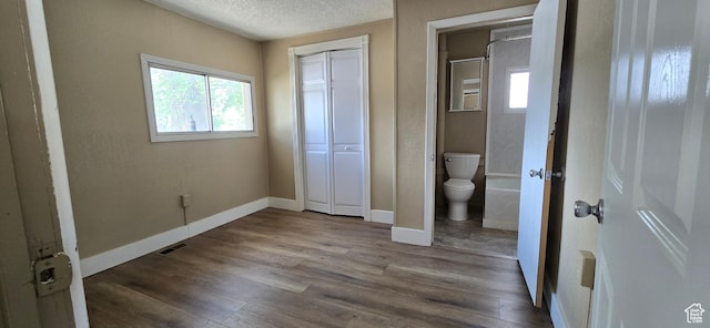 488 S 100 W, Price, UT 84501 - unfurnished bedroom featuring a textured ceiling, wood finished floors, baseboards, and a closet