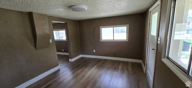 488 S 100 W, Price, UT 84501 - unfurnished room featuring dark wood-style floors, baseboards, and a textured ceiling
