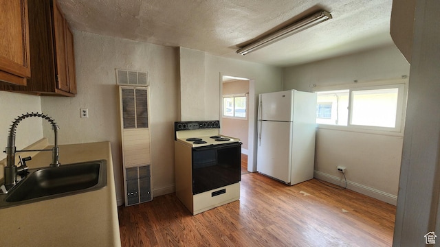 488 S 100 W, Price, UT 84501 - kitchen with white appliances, a sink, a heating unit, plenty of natural light, and a textured ceiling
