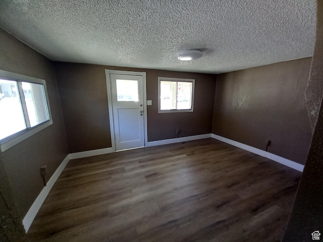 488 S 100 W, Price, UT 84501 - foyer with dark wood-type flooring, a textured ceiling, and baseboards