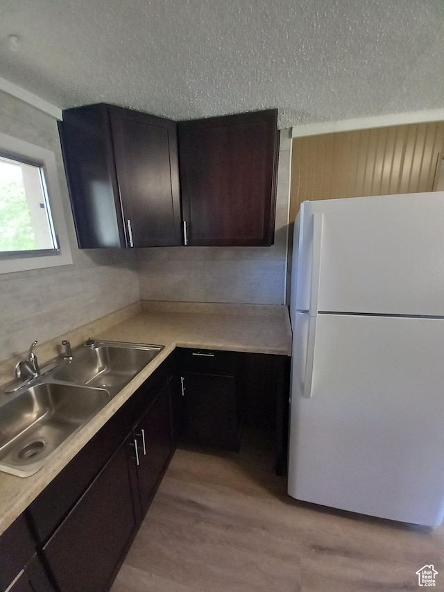 488 S 100 W, Price, UT 84501 - kitchen featuring freestanding refrigerator, a sink, light wood-style flooring, light countertops, and a textured ceiling