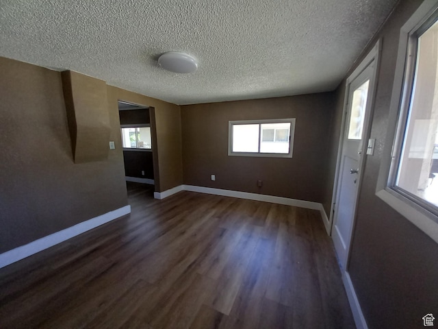 488 S 100 W, Price, UT 84501 - spare room featuring dark wood finished floors, a textured ceiling, baseboards, and healthy amount of natural light
