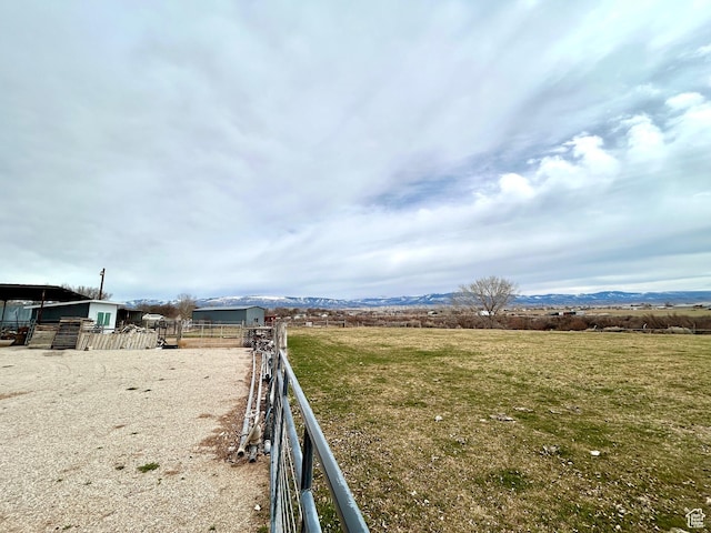 view of yard featuring fence and a rural view