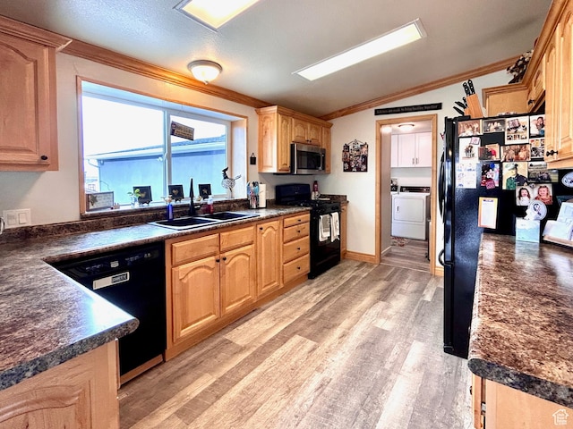 kitchen with ornamental molding, a sink, dark countertops, light wood finished floors, and black appliances