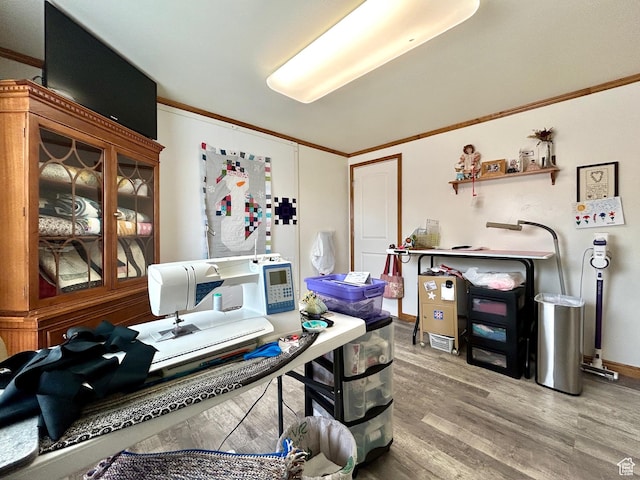 home office featuring baseboards, ornamental molding, and wood finished floors