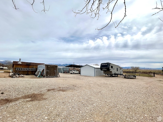 view of yard with an outbuilding and a shed