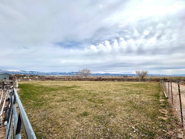 view of yard featuring fence and a rural view