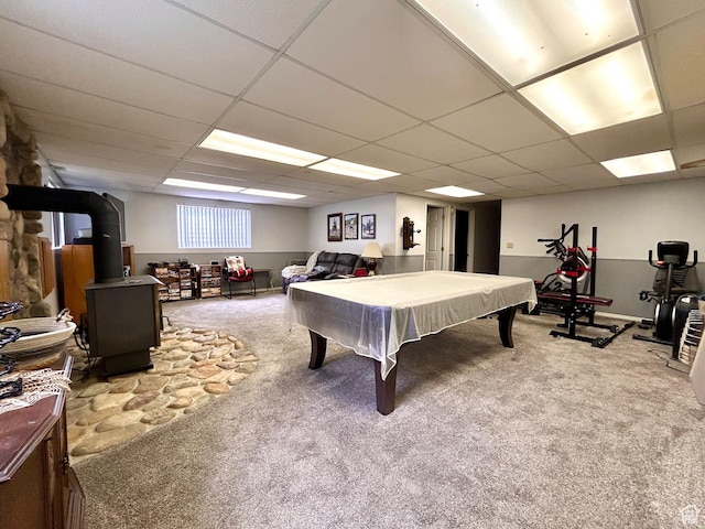 game room with a paneled ceiling, carpet floors, billiards, and a wood stove