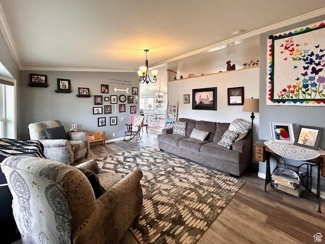 living area featuring plenty of natural light, crown molding, wood finished floors, and a chandelier