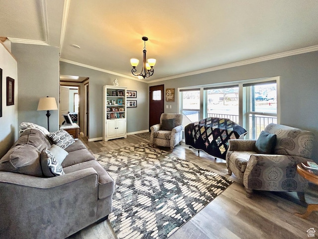 living area with a notable chandelier, crown molding, and light wood-style flooring