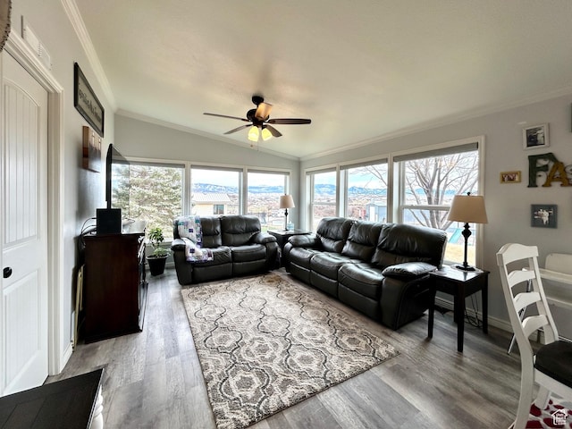 living area with crown molding, baseboards, ceiling fan, wood finished floors, and vaulted ceiling