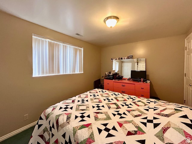 bedroom with baseboards and visible vents