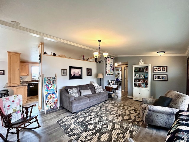 living area featuring a notable chandelier, wood finished floors, and ornamental molding