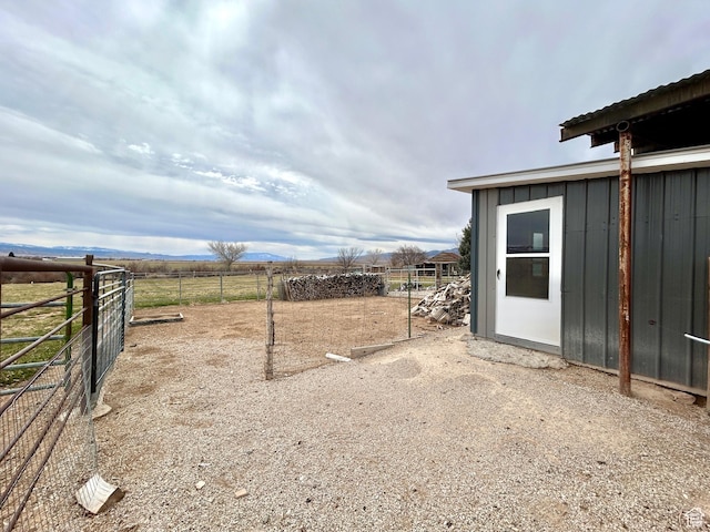view of yard featuring fence and a rural view