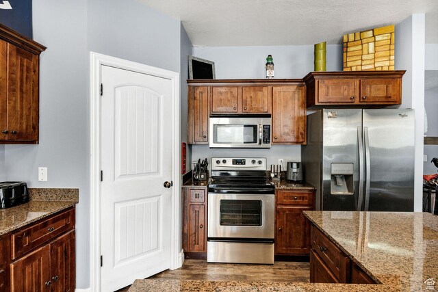 687 N 130 E, Smithfield, UT 84335 - kitchen with dark stone countertops, stainless steel appliances, and dark wood finished floors