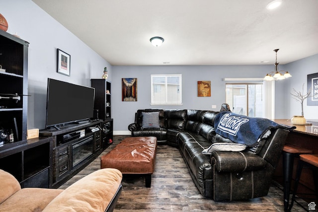 687 N 130 E, Smithfield, UT 84335 - living area with baseboards, wood finished floors, and a notable chandelier