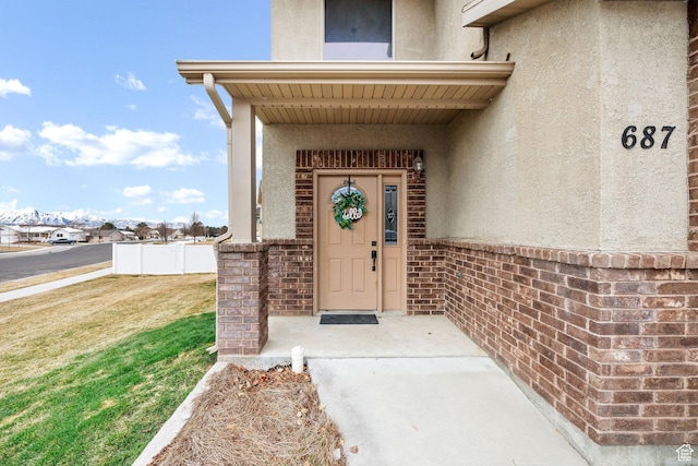 687 N 130 E, Smithfield, UT 84335 - view of exterior entry with stucco siding and a yard