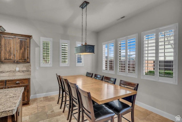 3308 S Red Sands Way, Hurricane, UT 84737 - dining room featuring stone tile flooring, a wealth of natural light, baseboards, and visible vents