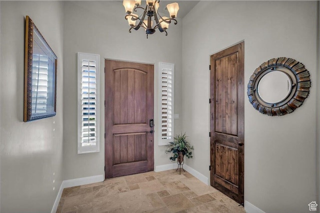 3308 S Red Sands Way, Hurricane, UT 84737 - entrance foyer featuring a healthy amount of sunlight, stone finish floor, baseboards, and a chandelier