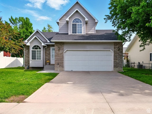 495 W 1330 N, Logan, UT 84341 - traditional home featuring concrete driveway, brick siding, and a shingled roof
