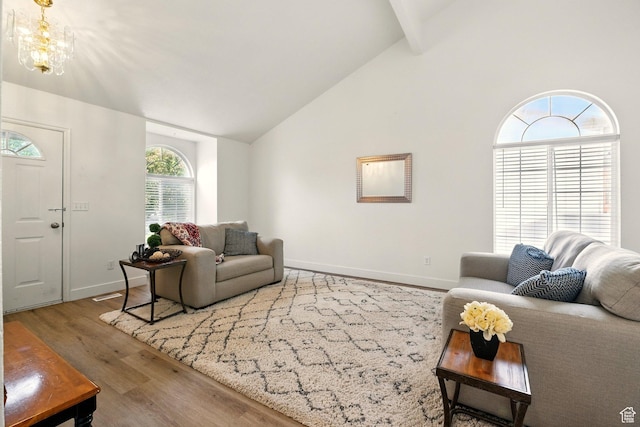495 W 1330 N, Logan, UT 84341 - living area featuring wood finished floors, high vaulted ceiling, a chandelier, and beam ceiling